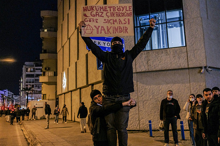 (EDITORS NOTE: Image contains profanity) A protester holds a placard saying "If the government is gassing like this, it's about to shit" during the demonstration. Following the arrest of Ekrem Imamoglu, the Istanbul Metropolitan Mayor of the Republican People's Party (CHP) protests across the country have increased. Thousands of people took to the streets to protest against the arrest of Ekrem Imamoglu.