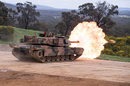An Abrams tank fires during an army firepower demonstration for guests and families at Puckapunyal Range in Victoria. The Australian Army put on a fire power display for guests and families at Puckapunyal Range, Australia. The display included Adrams Tanks and Artillery firing at moving and stationary targets. Around 400 people attended the event, from local primary school children to Grandparents of Soldiers.