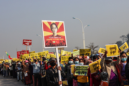 An anti-military coup protester holds a portrait of Aung San Suu Kyi while marching during a peaceful demonstration against the military coup in the Burmese-China border town Muse. A massive crowd took to the streets of Muse to protest against the military coup and demanded the release of Aung San Suu Kyi. The coup was originally incited due to Myanmar's military detaining State Counsellor of Myanmar Aung San Suu Kyi on February 01, 2021. They declared a state of emergency while seizing the power in the country for a year after losing the election against the National League for Democracy (NLD).