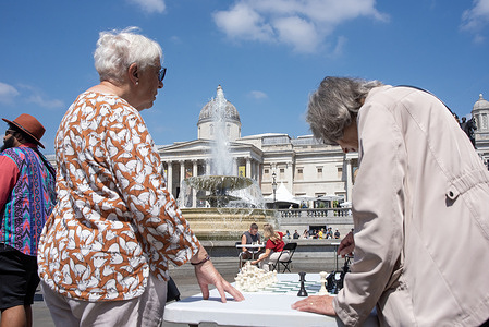 An elderly lady thinks about her next move during a chess festival in London. Thousands of people attended the fifth Chess Festival in Trafalgar Square in London. It is a free and family-friendly event, offering various chess activities and opportunities to meet with top players.