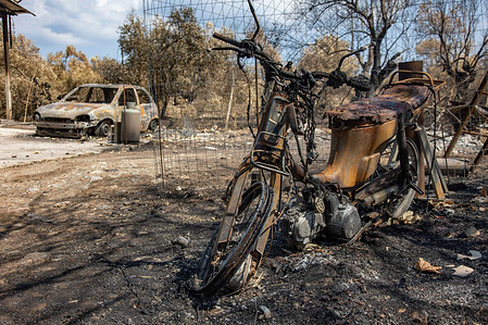 View of a burnt motorcycle and a car near Agia Anna.
The aftermath of the wildfires in the northern part of the Greek island of Evia (Euboea ) where fire kept burning almost for 10 days, burning forest and buildings. Almost 100,000 hectares of forest burned in Greek fires according to Copernicus European Emergency Services.