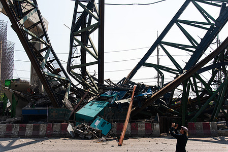 The wreckage of a collapsed construction crane seen at Rama II road in Samut Sakhon province, Thailand. At least 2 people was killed after the construction crane collapsed at the Rama II road in Samut Sakhon province, Thailand.