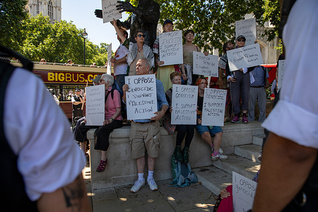 Supporters of Palestinian action hold placards during the rally. Supporters of the recently prescribed terrorist organisation Palestinian Action held a protest in Parliament Square Westminster. As the group is classed as a terrorist threat anyone showing support is liable to arrest and prosecution.