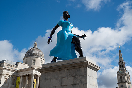 The Lady In Blue, the latest sculpture to be installed on the Fourth Plinth in Trafalgar Square, London. Lady In Blue, a bronze and blue sculpture by New York artist Tschabalala Self, has been unveiled on the Fourth Plinth in Trafalgar Square, London. Inspired by the idea of a contemporary “everywoman”, the sculpture depicts a young metropolitan woman walking forward with ambition and purpose. The figure is patinated using pigment refined from lapis lazuli, a semi-precious stone used by artists for centuries. Lady In Blue is the 16th artwork to occupy the Fourth Plinth since the commissioning programme began in 1998.