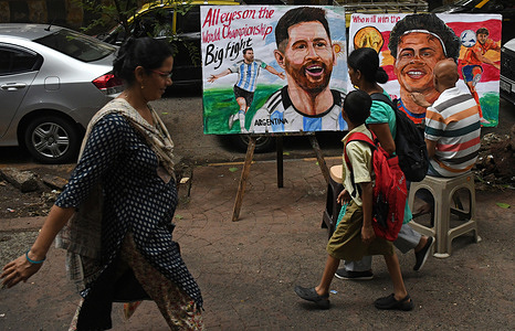 A teacher from Gurukul school of art paints a poster of Argentine football player Lionel Messi (L) and Spanish footballer Lamine Yamal (R) outside the art school ahead of ahead of the FIFA world cup final. The final FIFA world cup 2026 match will be held between Argentina and Spain at MetLife Stadium in East Rutherford, New Jersey.
