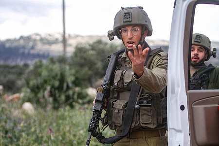 An Israeli soldier gestures with his hand during a military operation after the Israeli army forces killed Palestinian gunmen near Elon Moreh, east of Nablus, in the West Bank. Two Palestinian gunmen were shot dead by Israeli soldiers. According to Israeli Defence Minister Yoav Gallant, the two gunmen opened fire at the Israeli soldiers near the Jewish settlement of Elon Moreh, which caused the clashes between them and resulted in the death of the two Palestinian gunmen. The gunmen are identified as Mohammed Abu Dhraa and Soud al-Titi. Both their bodies were taken under the custody of the Israeli military.