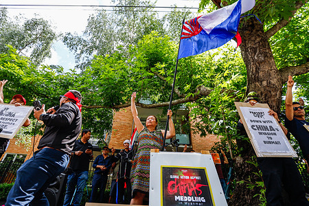 A protester waves the Karen ethnic flag while raising the three-finger salute during a rally against China's interference to Myanmar. People gathered Saturday in front of the Chinese consulate to protest against China’s support of Myanmar's military for arms supply, sham elections, and diplomatic backing, all of which perpetuate the suffering of the Myanmar people.