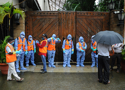 Municipal workers wearing personal protective equipment suits (PPE) stand outside the gate of Bollywood actor Amitabh Bachchan's bungalow.
Bollywood actor Amitabh Bachchan tested positive for coronavirus and has been admitted to a hospital where he is being kept in quarantine. The actor requested those who had come in close proximity in the past ten days to get themselves tested for the virus.