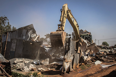 A bulldozer is seen ploughing through local homes that are closely packed by the Kenya Railways Land in Kibera.
Residents of Kibera slums residing close by the Nairobi Railway Drive experienced an early evacuation from their homes and businesses as they watched a bulldozer plough through their homes and small businesses without prior notice making many homeless and others jobless.