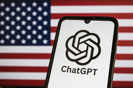 In this photo illustration, The US artificial intelligence company ChatGPT logo appears on a mobile phone with a Flag of USA in the background.