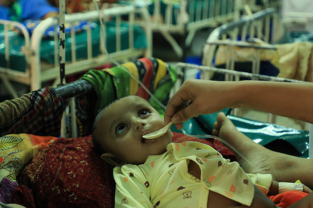 A mother takes care of her baby suffering from diarrhoea in a hospital. Diarrhoea patients are increasing at the International Centre for Diarrhoea Diseases Research, (ICDDR, B) due to the shortage of pure drinking water supplies in Dhaka city.