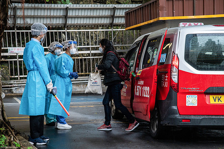 A passenger is greeted by staff at the Shau Kei Wan Designated COVID-19 Clinic.A fleet of around 300 designated taxis were launched recently to ferry passengers to and from designated COVID-19 clinics in Hong Kong. The drivers are provided with PPE and a 3000 HKD per day stipend from the government, while passengers ride for free (pending approval of their booking). Drivers are required to clean their vehicles thoroughly between rides, take regular COVID-19 tests, and passengers may only sit in the back.