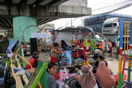 Residents take shelter under the Kalibata flyover during the aftermath of the floods in Jarkata.Floods submerged several houses on the banks of the Ciliwung River in the East and South of Jakarta areas.