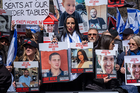 A woman holds up posters of hostages Omer Neutra and Amit Esther Buskila duing the rally.. Thousands of people gathered in Dag Hammarskold Plaza to call for immediate release of the remaining 133 hostages in Gaza. Hostages were taken six months ago when Hamas attacked Israel on October 7th, 2023. Among those present were hostages that have been released as well as family members of those still being held or killed. The rally was organized by The Hostages and Missing families Forum.