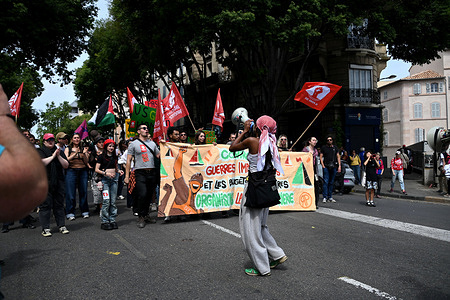Protesters holding a banner and flags march through the streets of Marseille chanting slogans during the demonstration. Thousands of protesters took part in the annual May Day (Labor Day) marking the international day of the worker, in Marseille.