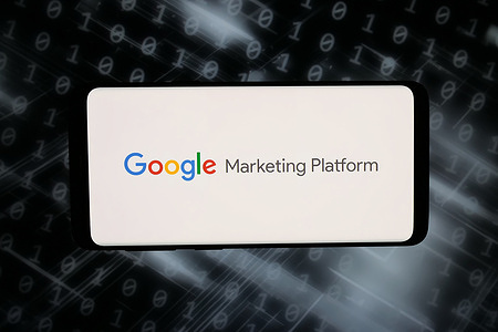 In this photo illustration, the logo of Google Marketing Platform is displayed on a smartphone in front of abstract background on computer screen.