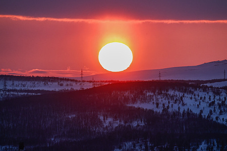 Sunset seen over a hill in the evening in Murmansk.