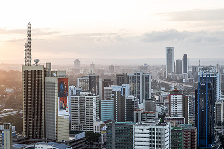 An aerial view of the modern Nairobi cityscape, capital city of Kenya in East Africa. The name Nairobi comes from the Maasai phrase Enkare Nyorobi, which translates to "place of cool waters". Besides its beautiful architectural cityscapes, the city is adjacent to the Nairobi National Park, a large game reserve known for breeding endangered wildlife.