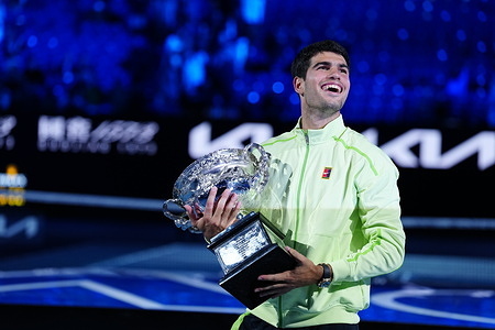 Carlos Alcaraz of Spain poses with the Norman Brookes Challenge Cup during the official presentation after defeating their Men's Singles final match with Novak Djokovic of Serbia during day 15 of the 2026 Australian Open at Melbourne Park.