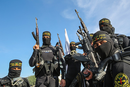 Members of Saraya Al-Quds fighters seen with guns, during a military parade.
Saraya al-Quds brigade’s fighters organized a military parade in the streets of Gaza city to celebrate the second anniversary of their leader’s memory (Baha Abu Al-Atta) who was killed by an Israeli air attack, two years ago and to declared a mobilization in defense of the prisoners in Israeli prisons and threaten Israel with war if it does not stop harassing and oppressing the Palestinian prisoners.