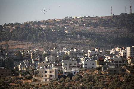 A view of the Palestinian buildings in the village of Deir al-Hatab, with the Jewish settlement of Olon Moreh east of Nablus in the West Bank in the background. Jewish settlers attacked Palestinian villages after a Jewish settler was killed in a shooting attack. And the two Palestinian perpetrators were killed in Gush Etzion.
