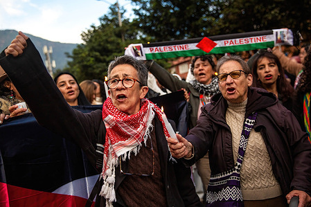 Women are seen shouting slogan in support of Palestinian people during the demonstration. Demonstrators gathered in front of the Palestinian embassy in Bogota in solidarity with the Palestinian people.