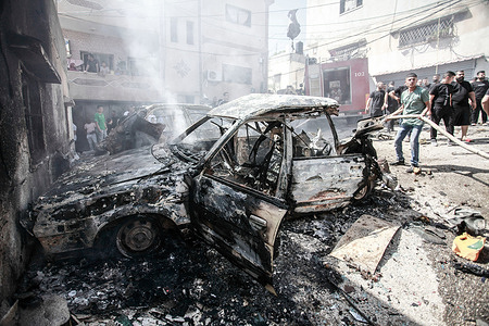 Firefighters extinguish burning Palestinian vehicles after the Israeli military operation in the Al-Faraa camp. A military operation by Israeli army forces in the Al-Faraa camp for Palestinian refugees in the West Bank resulted in the killing of a Palestinian, injuring dozens, and causing significant destruction to homes and infrastructure. The operation aimed to search for Palestinian militants.