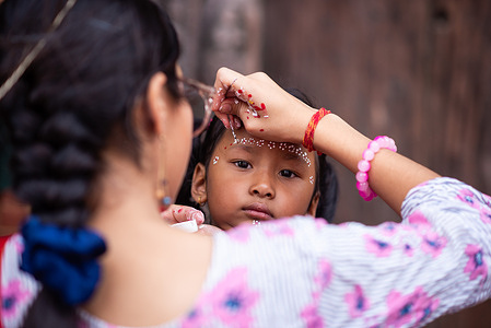 An artist seen making a color pattern on a child's face during Krishna Janmashtami festival at Patan Durbar Square. Krishna Janmashtami is an annual Hindu festival that celebrates the birth of Krishna, the eighth avatar of Vishnu. It is observed according to the Hindu lunisolar calendar on the eighth day of the Krishna Paksha in Shraavana or Bhadrapad which overlaps with August or September of the Gregorian calendar.