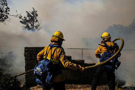 Firefighters extinguish a fire at Northwood High School in Irvine.
At about 6:47am on Monday, October 26, The Silverado Fire began as a brush fire in Silverado Canyon, California and as Santa Ana winds blew, the fire hit the city of Irvine in Orange County, California. The fire continues as firefighters currently are working to contain the fire.