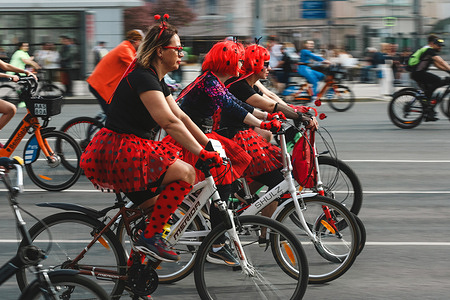 Women wearing festive ladybugs dresses ride bicycles during the annual Moscow Bike Event. Every year bicycle carnival brings together more than 40 thousand people on the Garden Ring Road (called Sadovoe Ring) in the center of Moscow