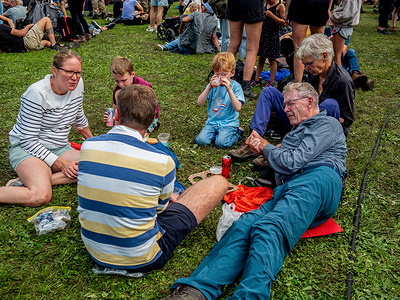 Participants are seen resting on the grass after the walk during the Airborne March. The Airborne March is the annual Dutch event every first Sunday of September that commemorates the Battle of Arnhem and reminds the post-Second World War generations of the sacrifices taken to restore freedom and democracy. The Battle of Arnhem was a battle during the Second World War at the vanguard of the allied operation Market Garden, an allied military operation of the combined US and British airborne forces. The Airborne March is also the world's biggest one-day memorial walking tour. Hence, 32,000 walkers are participating this year. The march is participated by veterans, living relatives, soldiers, British army cadets, air cadets, and civilians.