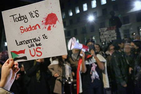 A protester holds a sign that reads 'Today it's Sudan, Tomorrow it will be US' during the demonstration. Protesters gathered across from Downing Street to oppose the UAE’s alleged support of the Rapid Support Forces (RSF) in Sudan, accusing it of complicity in genocide. They called for an end to Sudanese suffering and demanded that the UAE withdraw its support. The event was organized by Action For Sudan, a group advocating for human rights, justice, and self-determination for the Sudanese people.