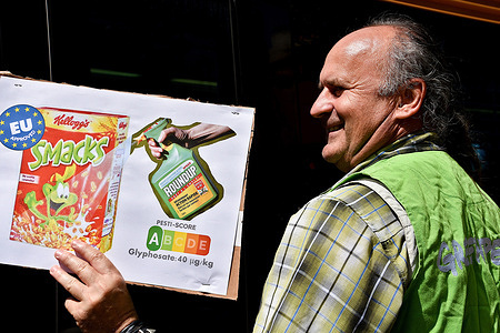 A protester holds a placard expressing his opinion during the demonstration. People took to the streets to protest against agribusiness giant Monsanto-Bayer and agrochemicals.