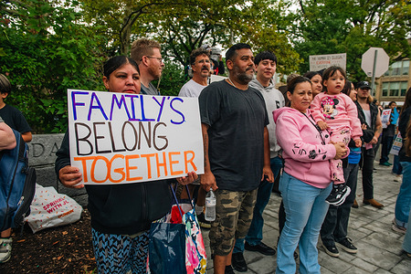 A woman seen holding a placard reading "Families Stay Together" during a demonstration against U.S. Immigration and Customs Enforcement (ICE) family separation practices. Demonstrators gather in solidarity during a rally against recent U.S. Immigration and Customs Enforcement (ICE) operations. Organizers estimated that over 1,000 people attended the demonstration citing local enforcement actions that advocates say resulted in nearly 100 detentions leaving many families without their primary earners.