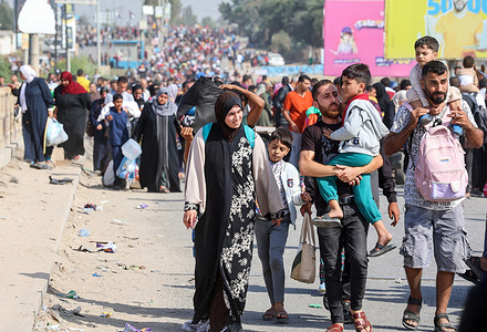 Palestinian families are seen walking along a road while evacuating from the ongoing battles between Israel and the Palestinian Hamas movement. For more than a month, thousands of Palestinians have been fleeing Gaza City and northern Gaza, making their way to the southern part of Gaza due to the ongoing intense conflict between the Palestinian armed group Hamas and the Israeli military. This conflict was sparked by an unprecedented attack by Hamas on October 7 in southern Israel, leading the Israel Defense Forces to respond with retaliatory bombings on Gaza.