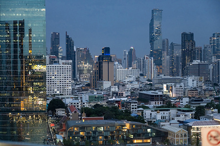 A night time panorama view of Bangkok's modern skyline rises above the Chao Phraya River, skyscrapers and office towers in the Sathorn business district reflect the city's role as Thailand's economic and financial centre.