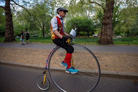 A participant of the London Tweed Run 2026 rides a Penny Farthing through St James's Park. The London Tweed Run takes place through Central London and nearby parks. Participants wear traditional tweed clothing and ride classic bicycles, including penny-farthings. The event is a social group ride focused on vintage style, cycling heritage, and enjoying a set route at a steady pace through the city.