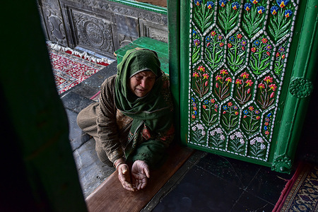 A Kashmiri Muslim woman weeps as she prays at the shrine of Khwaja Naqshband Sahib during the first Friday of Ramadan in Srinagar. Muslims throughout the world are marking the month of Ramadan, the holiest month in the Islamic calendar in which devotees fast from dawn till dusk.