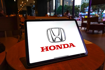 In this photo illustration, the logo of Honda is displayed on the screen of a tablet.