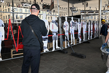 A man is seen reading the texts on the placards displayed at the "435-1 killed me" exhibition. The association "Stop aux violences d'État" (Save) installed its travelling exhibition "435-1 m’a tué.e" on the Old Port of Marseille on April 26, 2026 to denounce and demand the repeal of article L.435-1 which expands the use of firearms by the police.