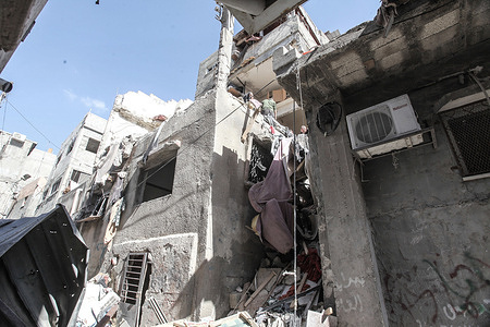 Palestinians inspect the effects of destruction that followed the building in which Palestinian militants from the Tulkarm Brigade were holed up. The Palestinian Ministry of Health said that one person was killed and a number of others were injured during the air strike. An Israeli Air Force carried out a raid on a building in the Nour Shams camp, east of Tulkarm in the West Bank.