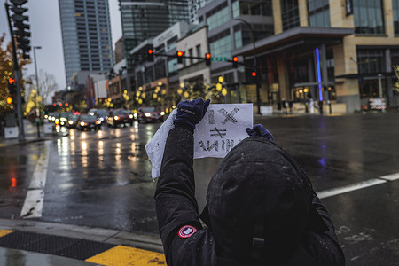 A protester holds a placard during the demonstration. Protesters held a rally under the heavy rain in solidarity with the Urumqi people in Bellevue, Seattle. In China, the "white paper" was known as the "A4 Revolution". In Bellevue Downtown Park, around twenty protesters gathered to demonstrate against China's "zero-covid" policy and to pray for the victims of the tragic fire in Urumqi.