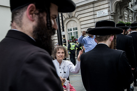 A woman saying "shame on you" to the Orthodox Jews supporters of Palestine.

Hundreds of anti-Israel protesters marched through the streets on the annual Al Quds Day. Started by the Ayatollah Khomeini in 1979 to show support for Palestine and oppose the existence of Israel and the counter protest from the Zionist Federation.