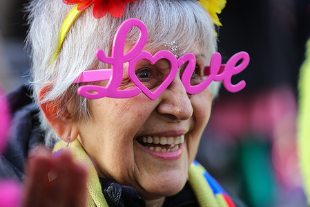 A party goer wears extravagant ëLoveí spectacles during the celebration. Revelers met on Valentines Day to reclaim love around the base of the Eros statue in Piccadilly Circus in London. They dressed in bright costumes, sing, dance and held hands in a circle to flood the city with their love in an attempt to turn the tide, while wishing all beings in all worlds happiness and peace Revelers met on Valentine's Day to reclaim love around the base of the Eros statue in Piccadilly Circus in London. They dressed in bright costumes, sang, and held hands in a circle to flood the city with their love in an attempt to turn the tide, while wishing all beings in all worlds happiness and peace.