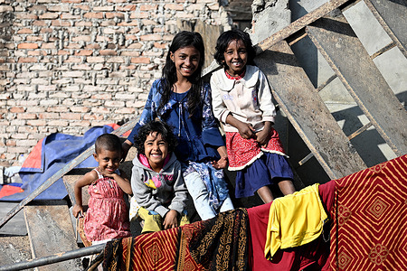 Children in the Korail slum pose for a photo after the devastation left by fire out break in Dhaka.