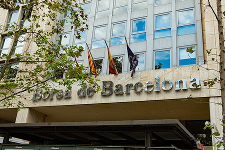 Flags seen hanging on the building of the Stock Exchange of Barcelona.