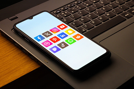 In this photo illustration, the social networks - Facebook, X (Twitter), Instagram, YouTube, Pinterest, LinkedIn, Snapchat, Twitch, TikTok, WhatsApp and Reddit logos is seen displayed on a smartphone screen.
