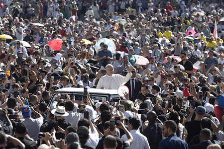 Pope Leo XIV waves to the faithful as he arrives for his weekly general audience in St. Peter's Square at the Vatican.