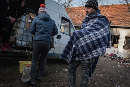 On an abandoned farm property near the Hungarian border a charity distributes drinking water to a group of refugees and migrants from Pakistan, Nepal, India and Afghanistan. 

Hungary and Croatia have been tightening their border controls over recent years which has resulted in many refugees and migrants becoming stuck in Serbia.