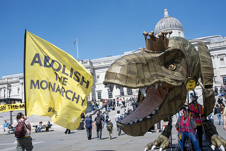 An activist waves a flag by the T-Rex puppet named "Chuck the Rex" standing on the Trafalgar Square in London during the Republic Day. The T-Rex symbolises the monarchy as a bygone era. The Republic Day is on the 10th of May in the UK. It is organised by an anti-monarchist group called Republic. It is a campaign to raise awareness and advocate for a democratic alternative to the monarchy according to their website.